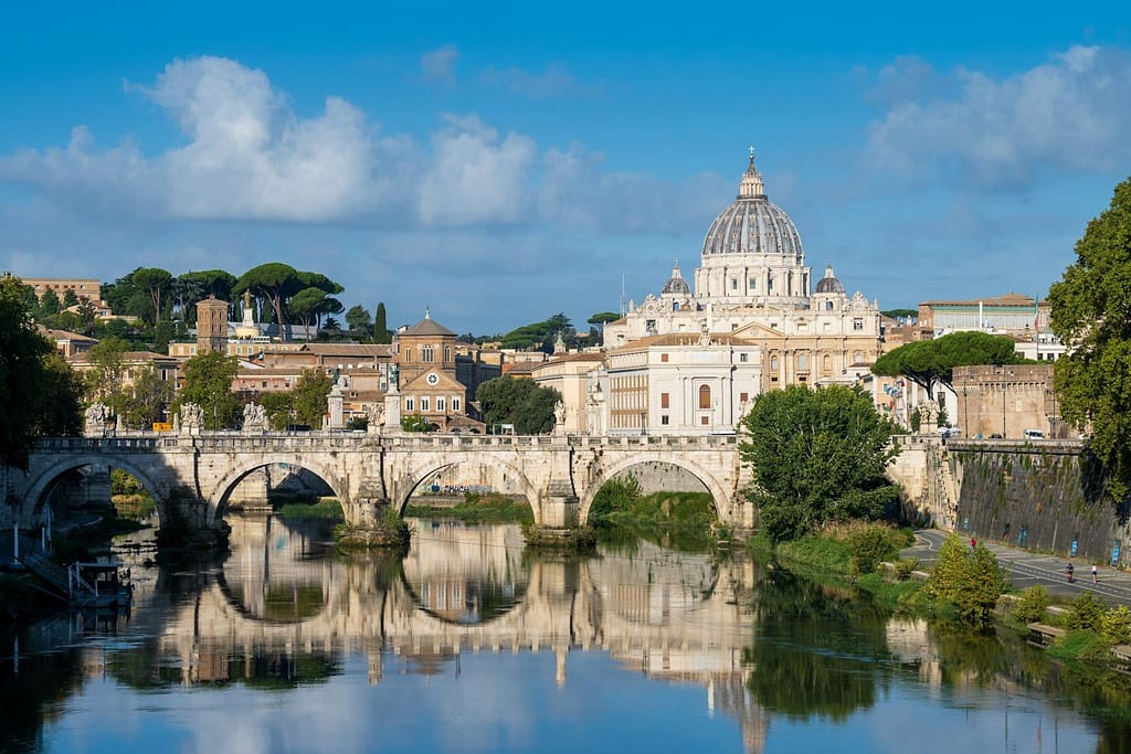 a bridge over a body of water with a building in the background